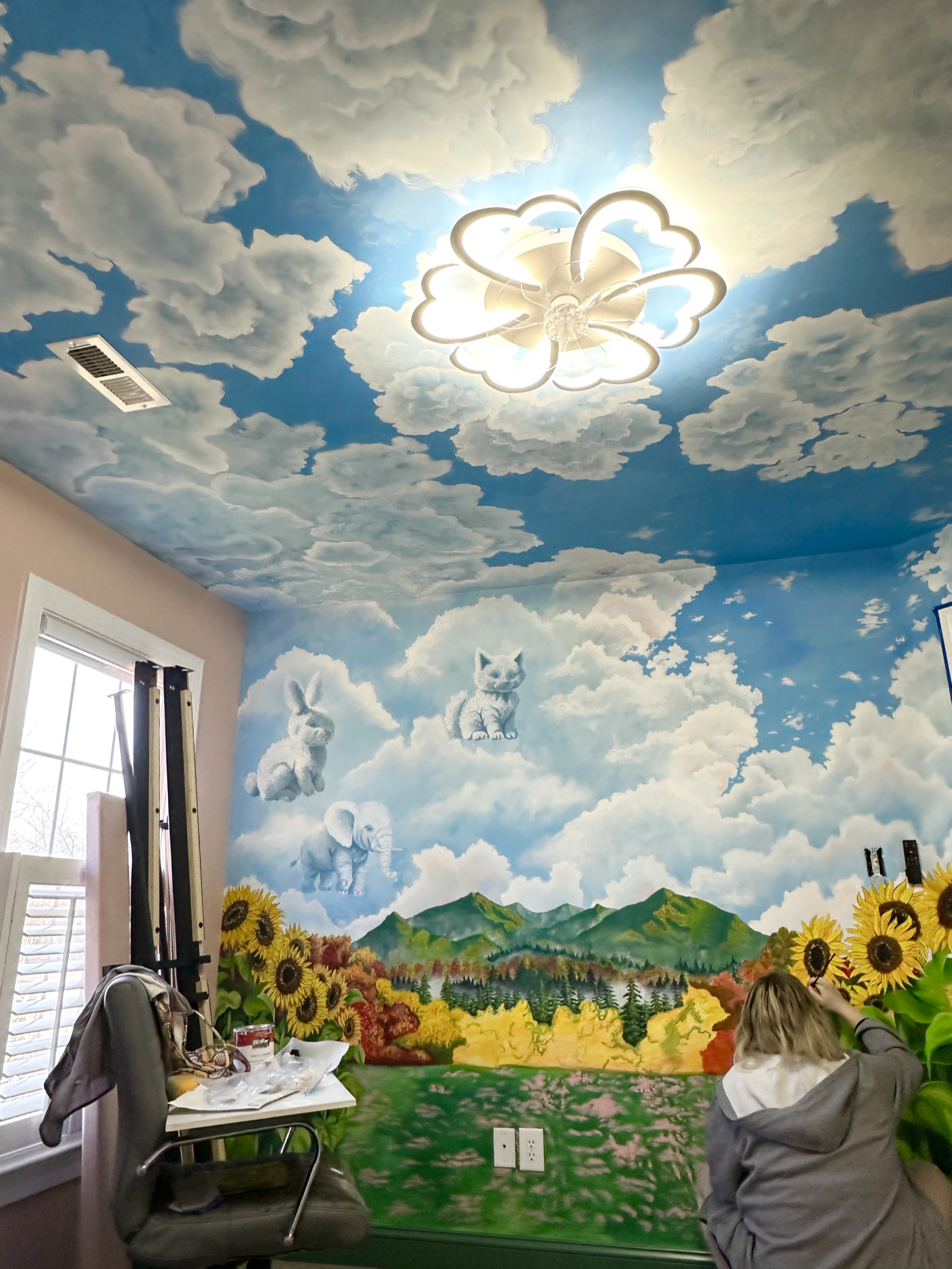 Artist painting the mural wall