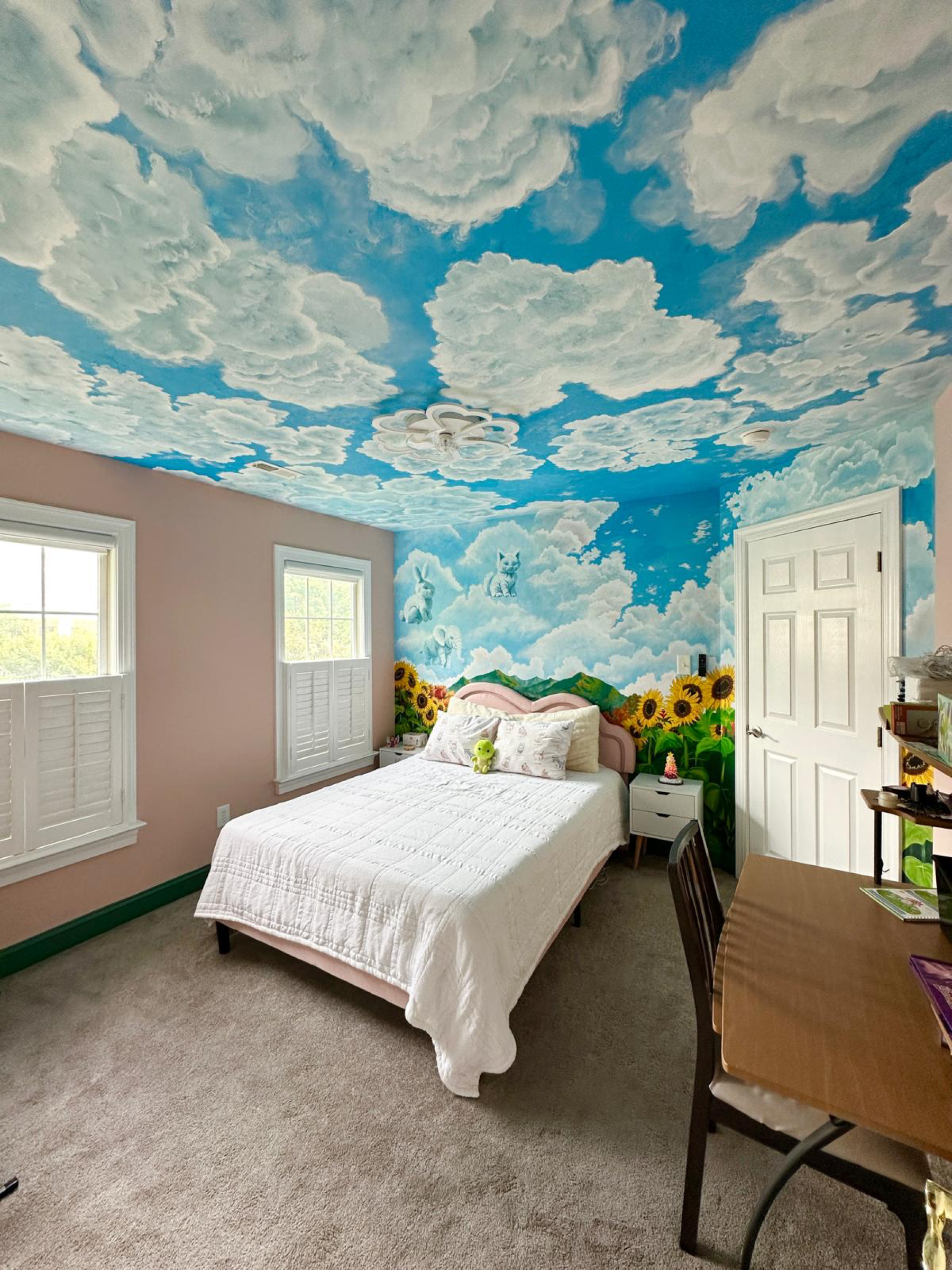 Completed Where Dreams Float mural room with clouds, animals, mountains, and sunflowers